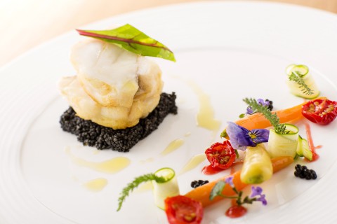 Monkfish, black couscous, seared vegetables, lobster bisque
